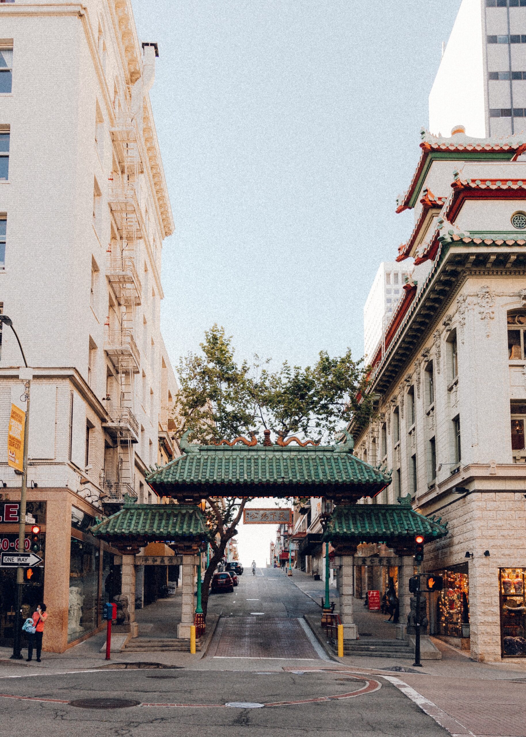Green-tiled Chinatown gate between city buildings